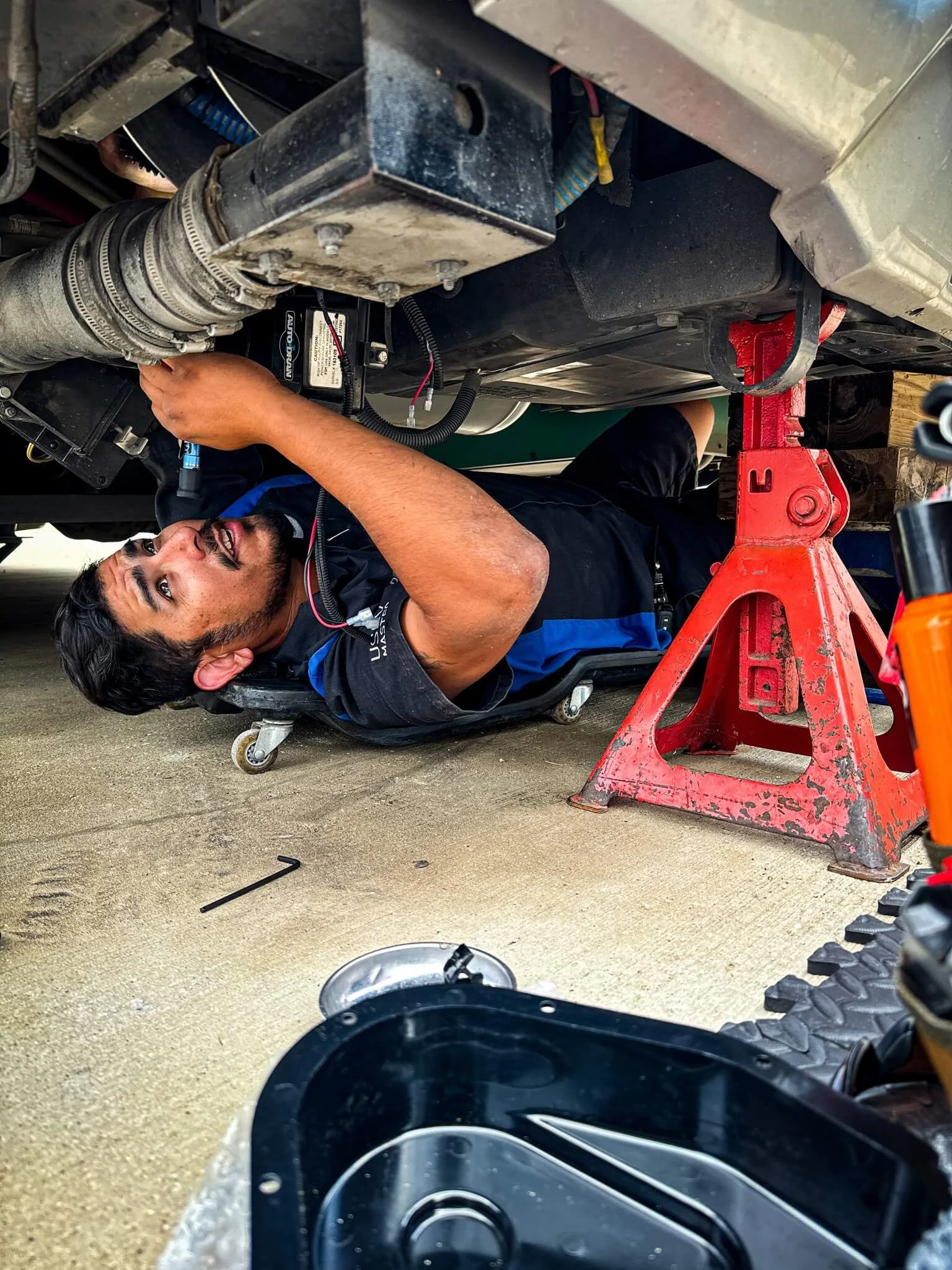 Certified RV Technician At Work Blue Moon RV technician Adrian performing hands-on diagnostics inside a motorhome service bay