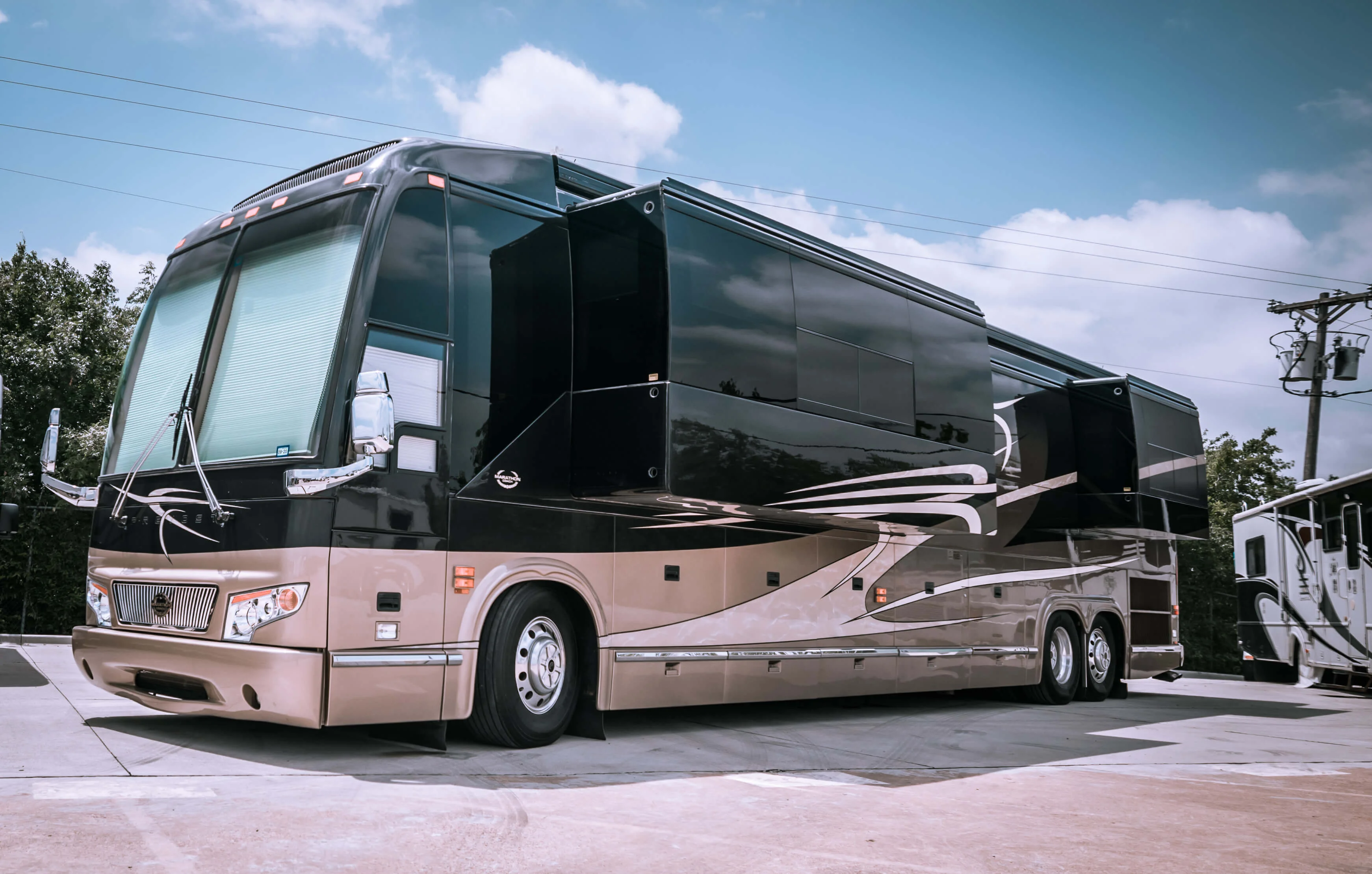 RV Exterior Slide-Out Setup Luxury motorhome parked with slide-outs extended during service preparation at Blue Moon Mobile RV