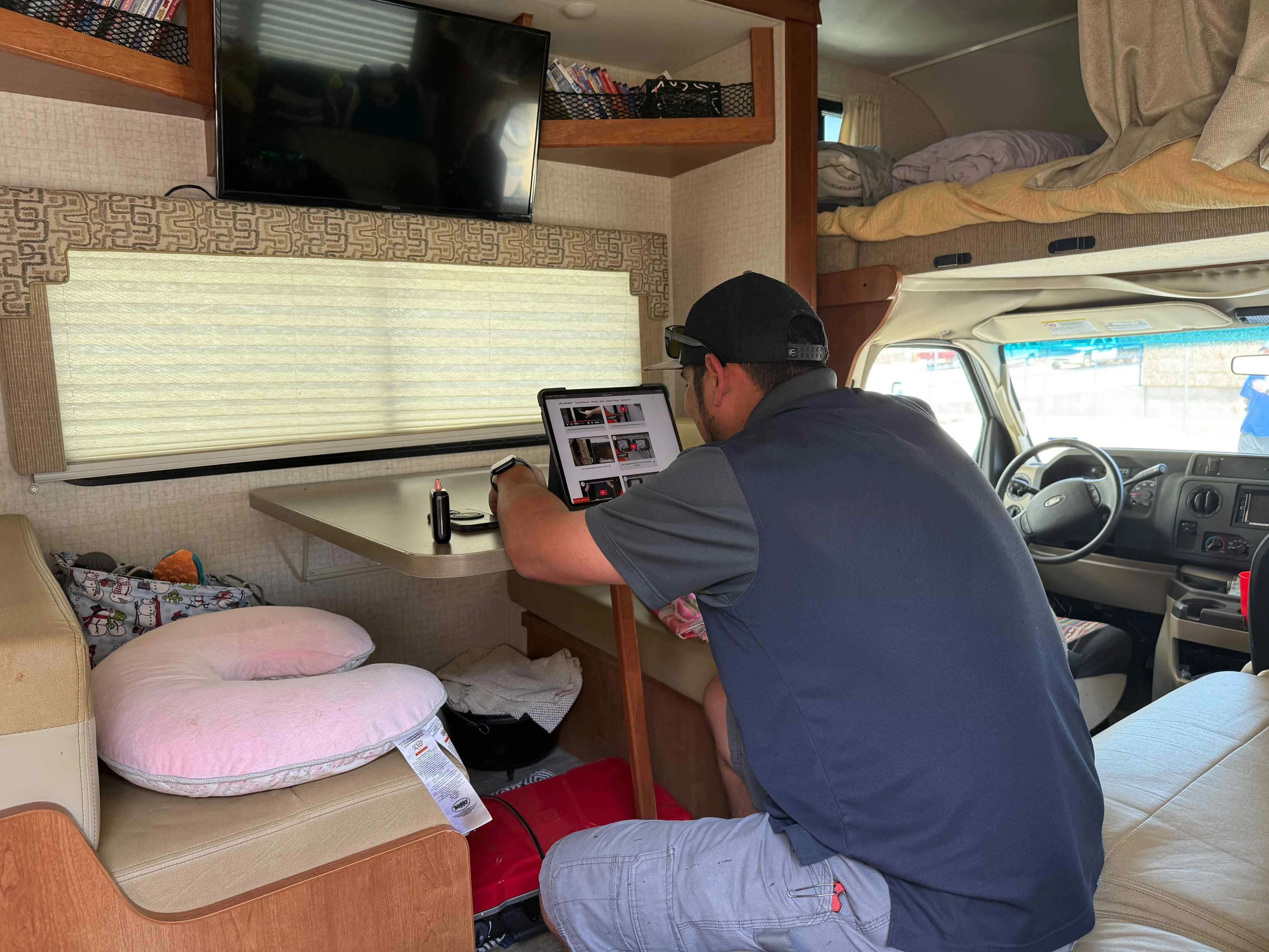 RV Service Bay Inspection RV service work in progress with open compartments and active systems inspection